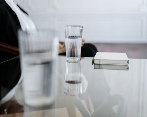 water and notebook on a work desk
